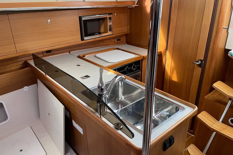 Slide: The Image of Interior of 2014 Catalina 355 yacht kitchen with sink, stove, and microwave. - 13