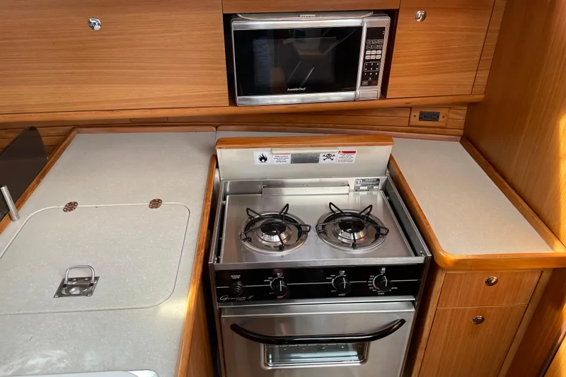 Slide: The Image of Catalina 355 yacht kitchen with stove, oven, and microwave, 2014 model. - 15