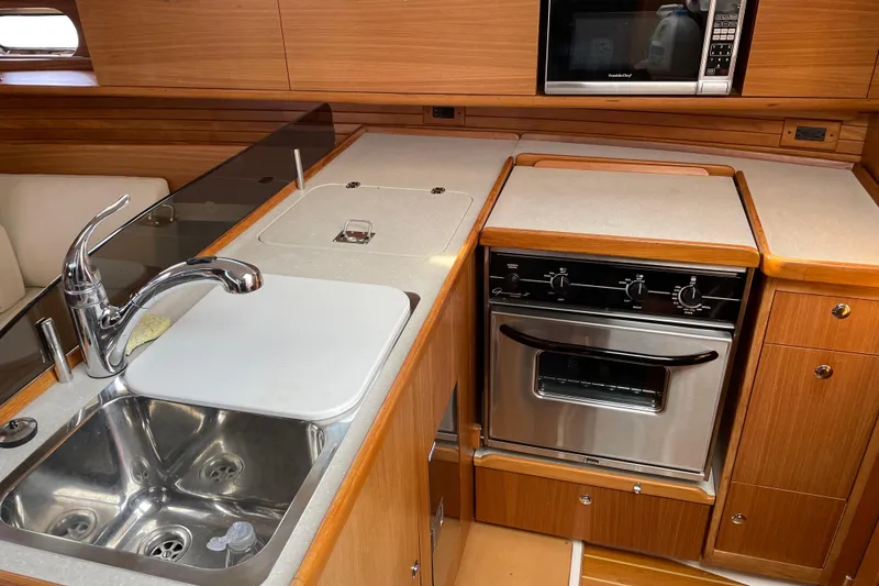 Slide: The Image of Modern kitchen in 2014 Catalina 355 yacht with sink, oven, and microwave. - 16