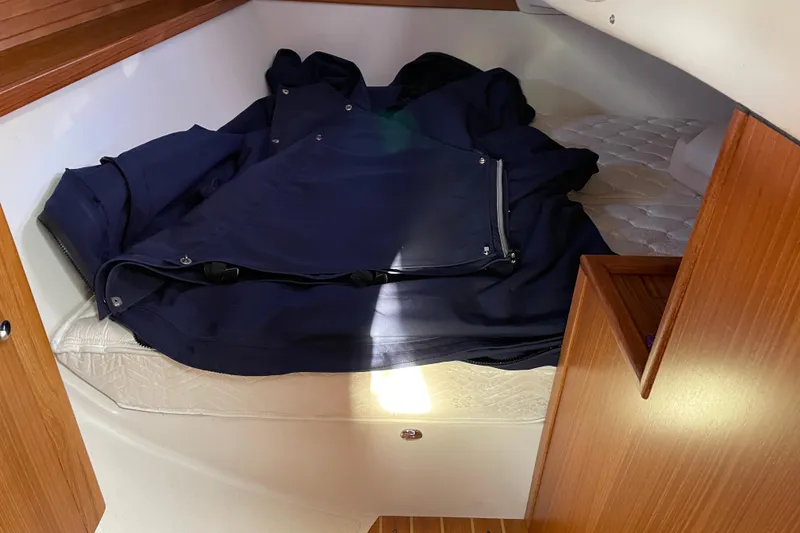 Slide: The Image of Cozy cabin interior of a 2014 Catalina 355 sailboat with a neatly folded navy jacket. - 17