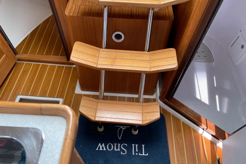 Slide: The Image of Interior of a 2014 Catalina 355 sailboat with wooden steps and flooring. - 18