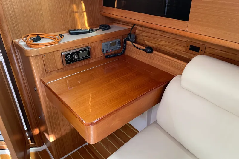Slide: The Image of Navigation station inside 2014 Catalina 355 yacht with wooden desk and communication equipment. - 20
