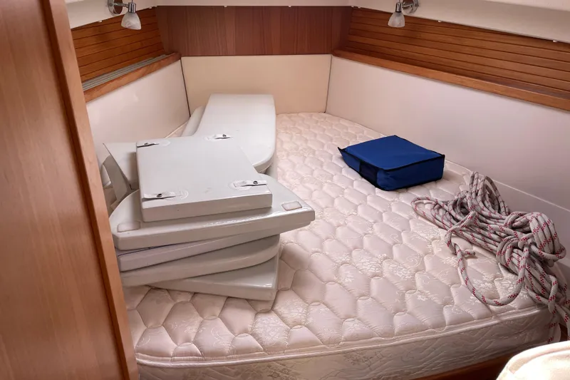 Slide: The Image of Interior of 2014 Catalina 355 sailboat with mattress, cushions, and coiled rope. - 23