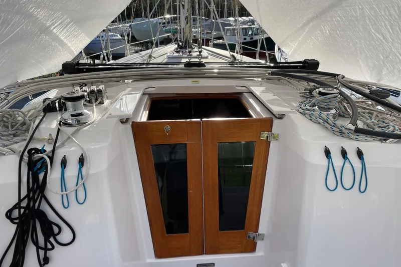 Slide: The Image of Cockpit view of a 2014 Catalina 355 sailboat with ropes and wooden hatch. - 28