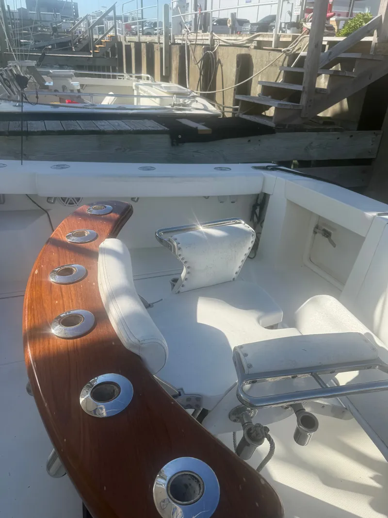 Slide: The Image of 2008 Rampage EXPRESS boat with fishing rod holders at dock. - 13