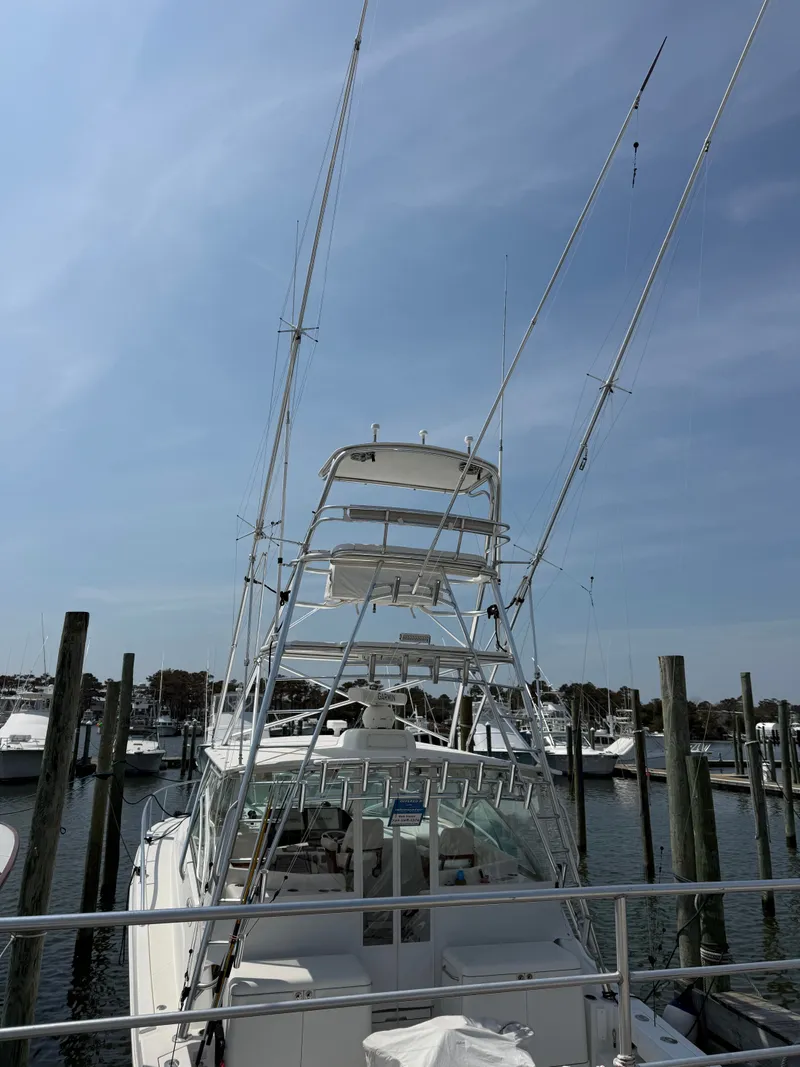 Slide: The Image of 2008 Rampage EXPRESS boat docked under clear sky. - 2