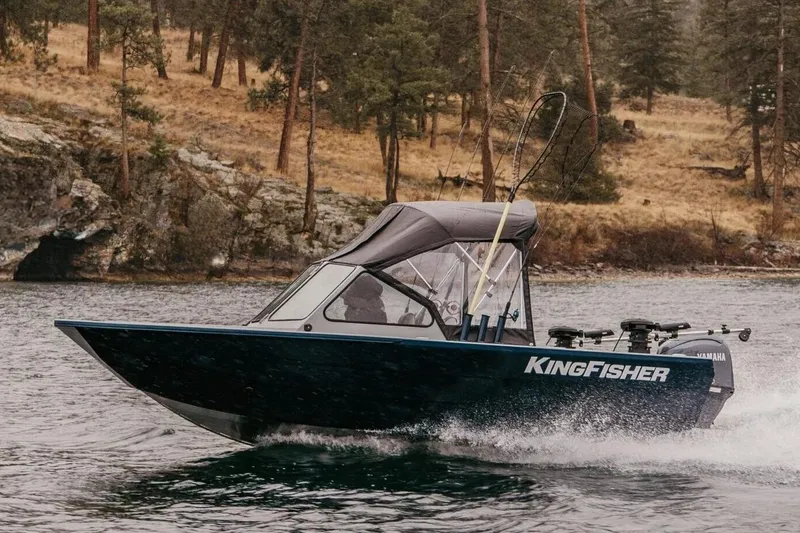 The Image of Manufacturer Provided Image: 2026 KingFisher 16 Falcon boat cruising on a scenic lake with forested shoreline. - 0