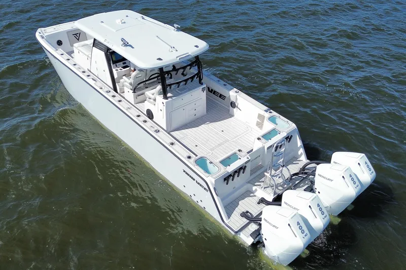 Slide: The Image of 2025 Twin Vee 400 GFX2 CC boat on water, featuring powerful Mercury engines. - 3
