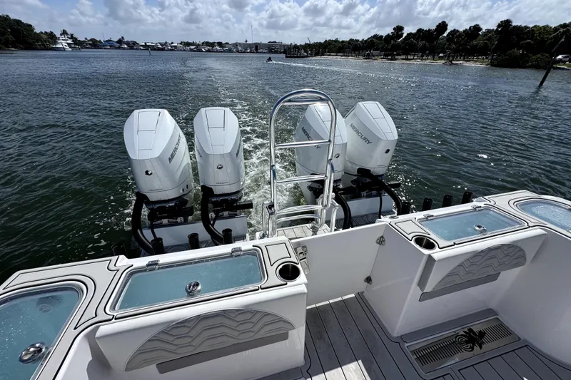 Slide: The Image of 2025 Twin Vee 400 GFX2 CC boat with four Mercury outboard engines on water. - 5