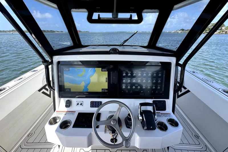 Slide: The Image of Cockpit of 2025 Twin Vee 400 GFX2 CC boat with advanced navigation displays. - 6