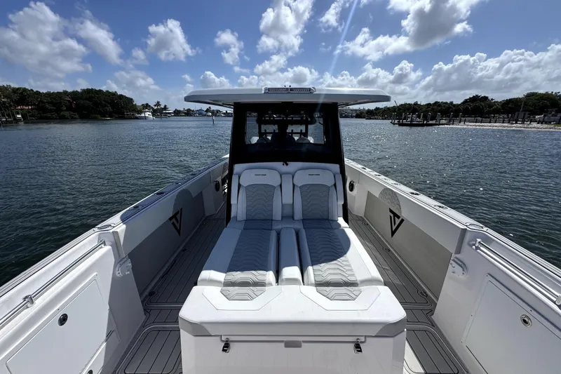 Slide: The Image of 2025 Twin Vee 400 GFX2 CC boat with luxurious seating on a sunny day. - 9