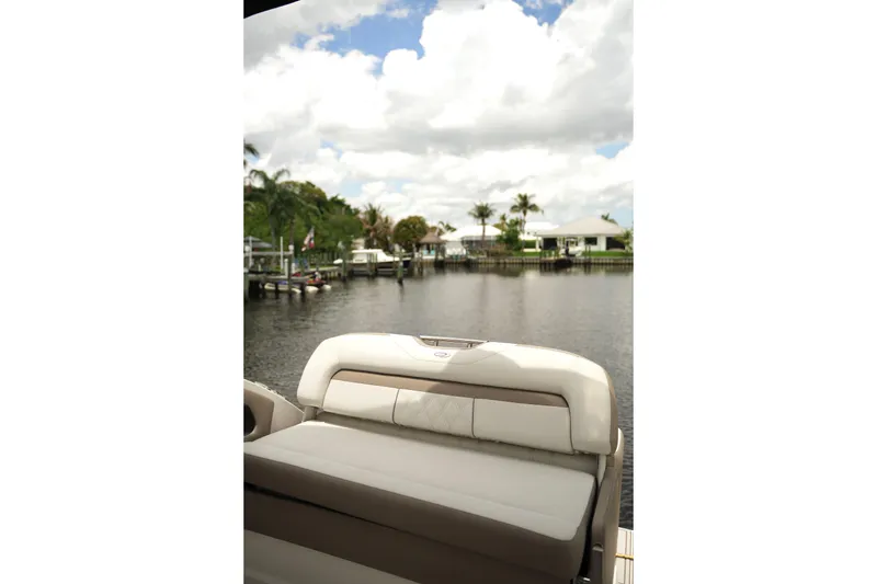 Slide: The Image of 2018 Regal 28 Express boat with scenic waterfront view and palm trees. - 11