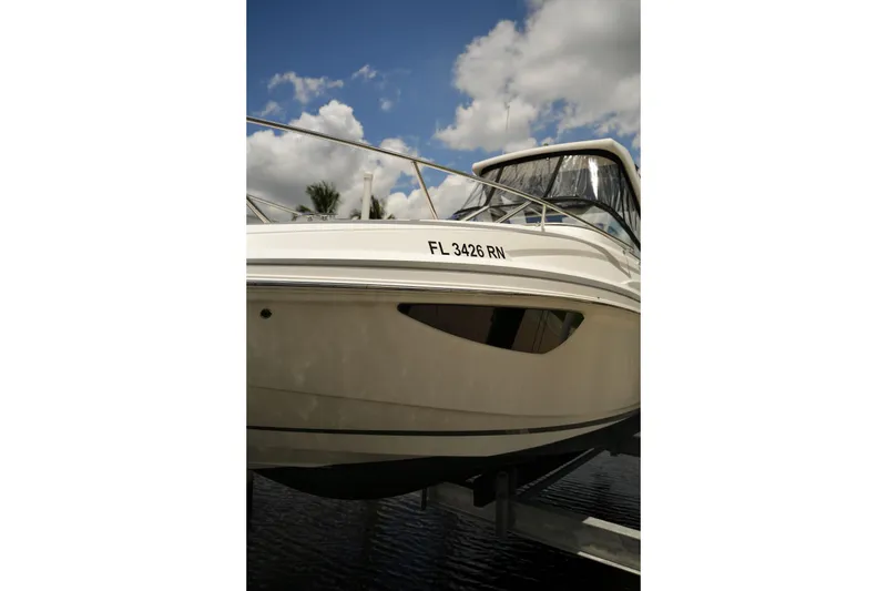 Slide: The Image of 2018 Regal 28 Express boat with registration FL 3426 RN, docked under a cloudy sky. - 14