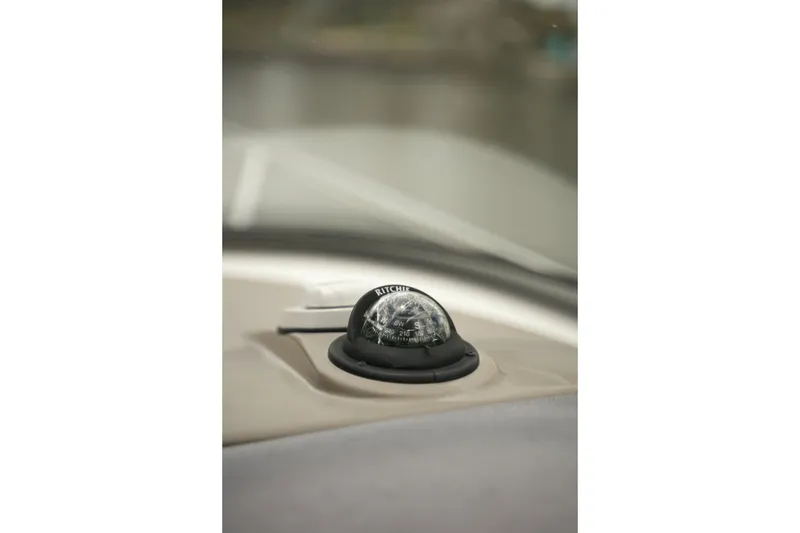 Slide: The Image of Compass on 2018 Regal 28 Express boat dashboard, close-up view. - 16