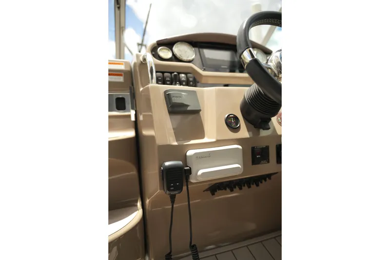 Slide: The Image of Control panel of a 2018 Regal 28 Express boat with steering wheel and gauges. - 18