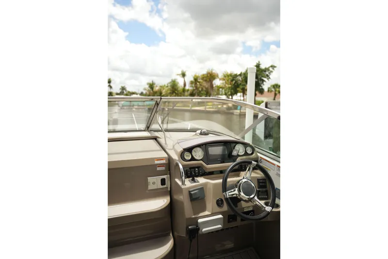 Slide: The Image of 2018 Regal 28 Express boat cockpit with steering wheel and dashboard controls. - 21