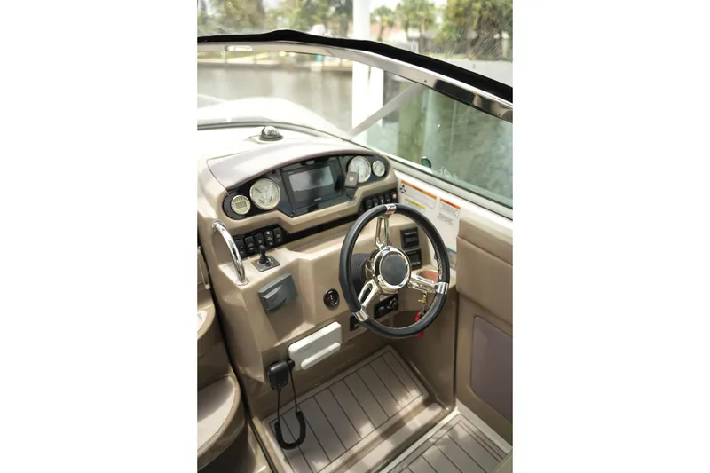 Slide: The Image of Cockpit of 2018 Regal 28 Express boat with steering wheel and control panel. - 25