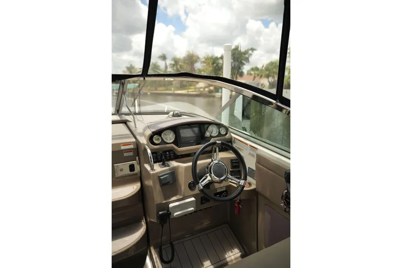 Slide: The Image of Cockpit of 2018 Regal 28 Express boat with steering wheel and dashboard controls. - 26
