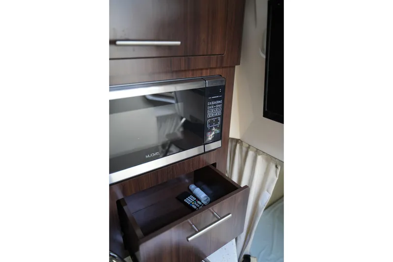 Slide: The Image of Microwave and drawer in 2018 Regal 28 Express boat interior. - 28
