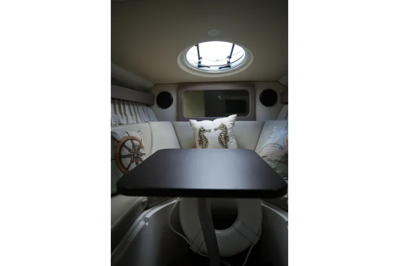 Slide: The Image of Interior of 2018 Regal 28 Express boat with cozy seating and nautical decor. - 29