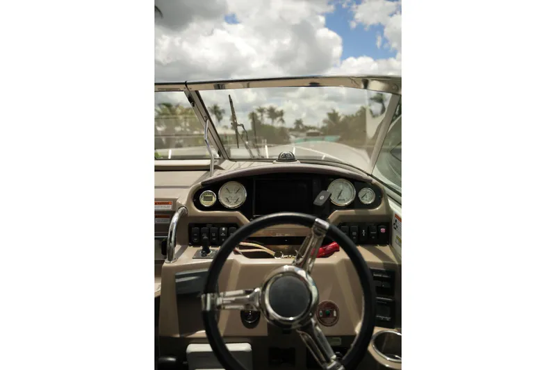 Slide: The Image of Cockpit view of a 2018 Regal 28 Express boat with steering wheel and gauges. - 3