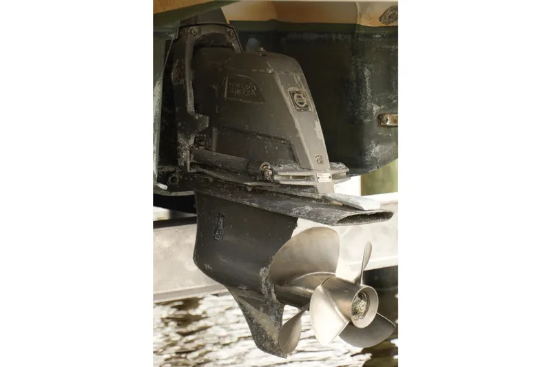 Slide: The Image of Close-up of a 2018 Regal 28 Express boat propeller and outdrive in water. - 31