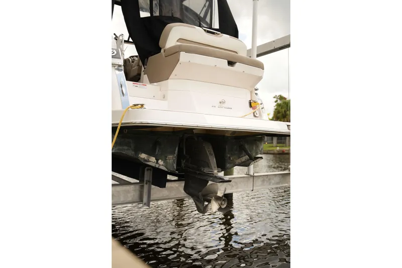 Slide: The Image of 2018 Regal 28 Express boat stern view with propeller above water. - 32