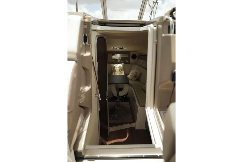 Slide: The Image of Interior view of 2018 Regal 28 Express boat cabin with seating and table. - 38