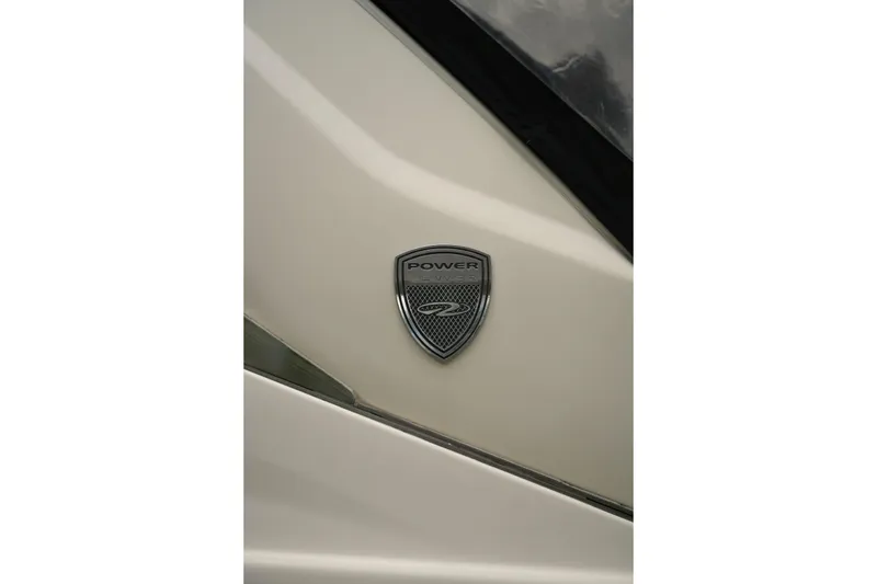 Slide: The Image of Close-up of 2018 Regal 28 Express boat emblem on a sleek white surface. - 6