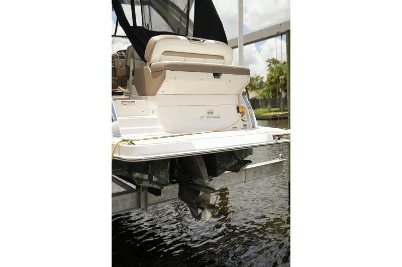 Slide: The Image of Rear view of a 2018 Regal 28 Express boat docked by the water. - 8