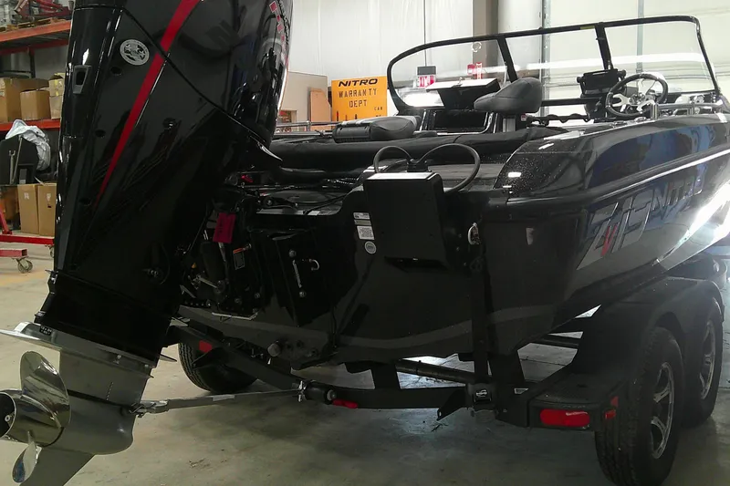 Slide: The Image of 2026 Nitro ZV19 Sport Pro boat with powerful outboard motor in a showroom. - 2