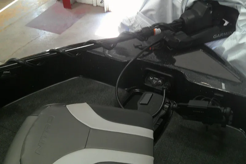 Slide: The Image of 2026 Nitro ZV19 Sport Pro boat interior with Garmin equipment and cushioned seating. - 4