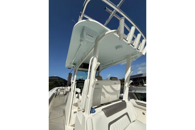 Slide: The Image of 2023 World Cat 325 CC boat interior with seating and rod holders under clear blue sky. - 17