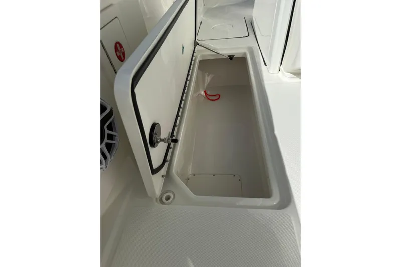 Slide: The Image of Open storage compartment on 2023 World Cat 325 CC boat deck. - 18