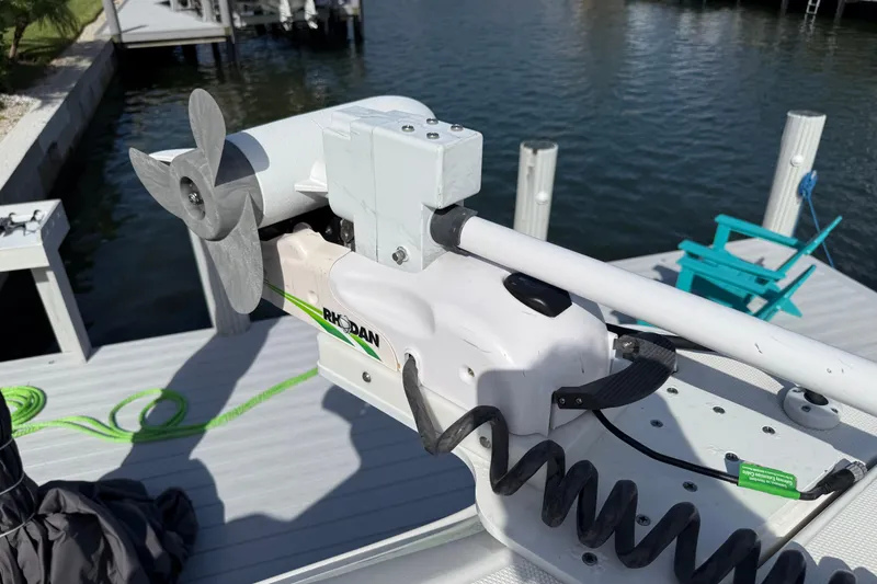 Slide: The Image of Rhoden trolling motor on a 2023 World Cat 325 CC boat docked by the water. - 19