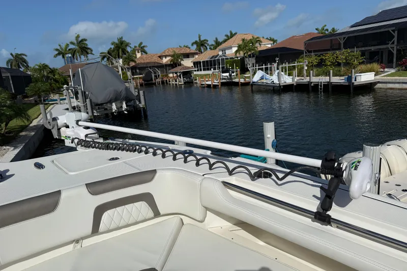 Slide: The Image of 2023 World Cat 325 CC boat docked in a scenic canal with palm trees. - 20