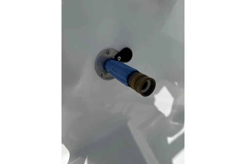 Slide: The Image of Close-up of a blue hose connector on a 2023 World Cat 325 CC boat. - 26