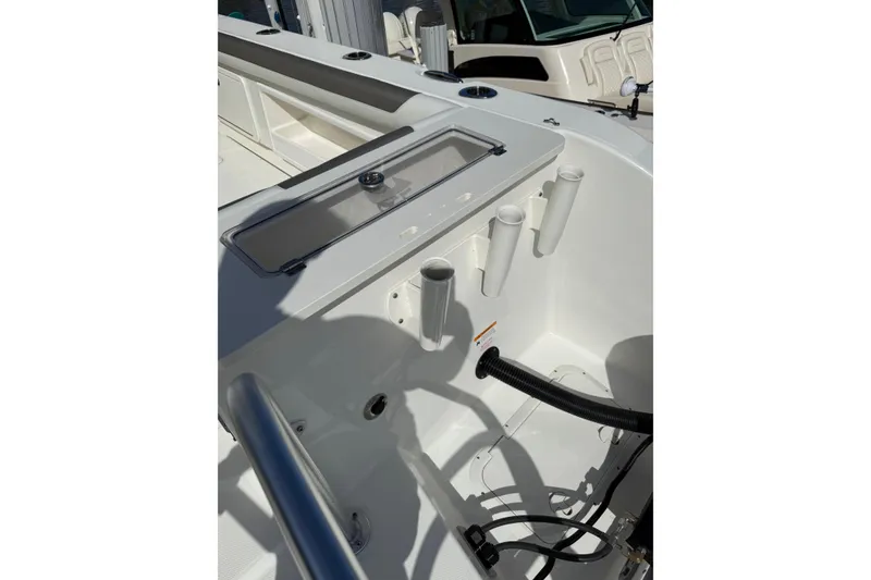 Slide: The Image of 2023 World Cat 325 CC boat interior with rod holders and storage compartments. - 27