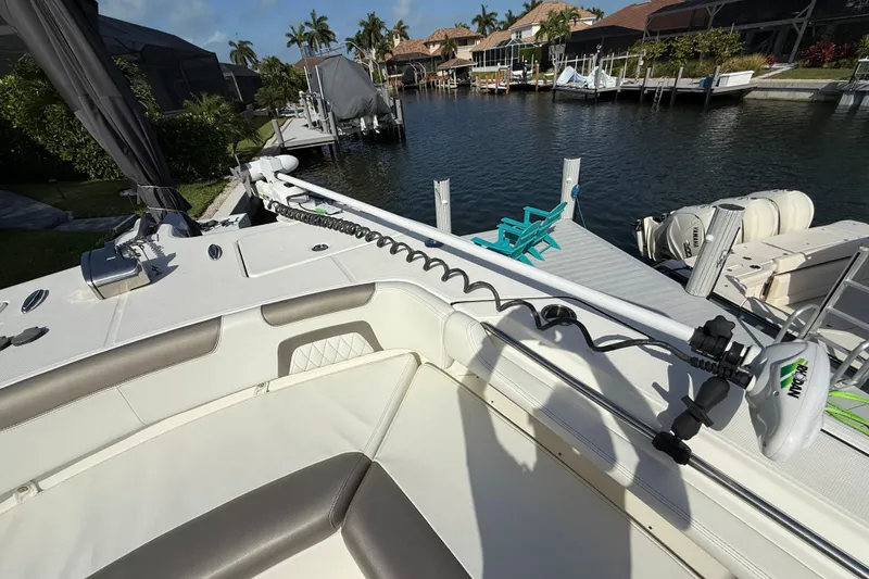 Slide: The Image of 2023 World Cat 325 CC boat docked, featuring a Minn Kota trolling motor. - 31