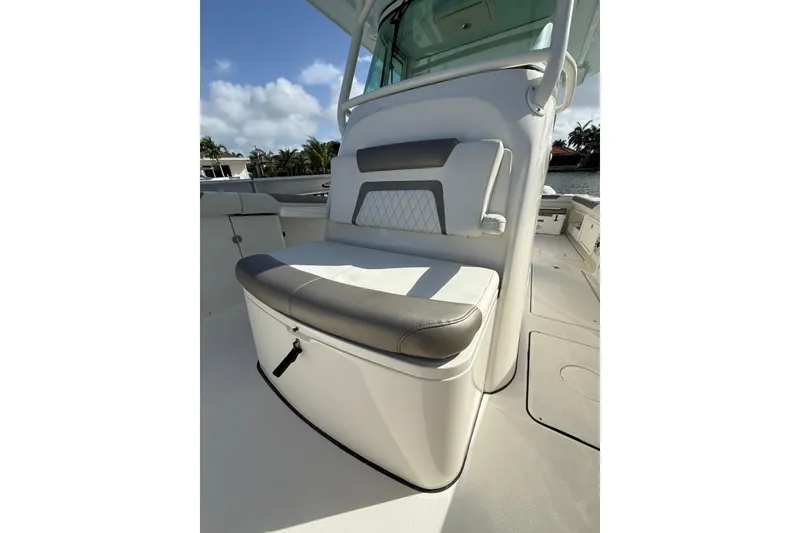 Slide: The Image of 2023 World Cat 325 CC boat interior with cushioned seating and storage compartment. - 37