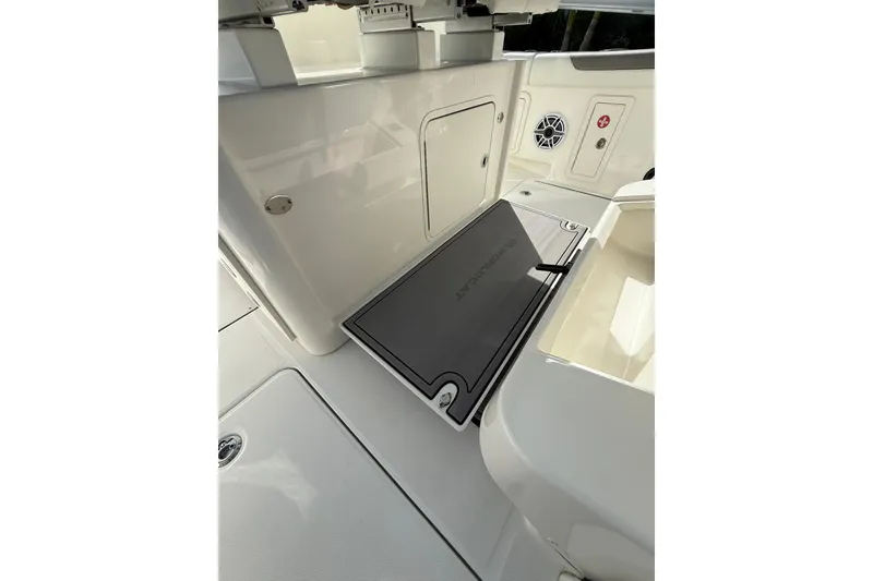 Slide: The Image of 2023 World Cat 325 CC boat interior with storage compartments and sleek design. - 38