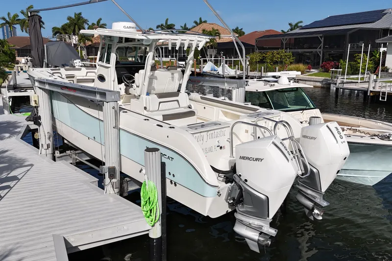 Slide: The Image of 2023 World Cat 325 CC boat docked with twin Mercury engines. - 4