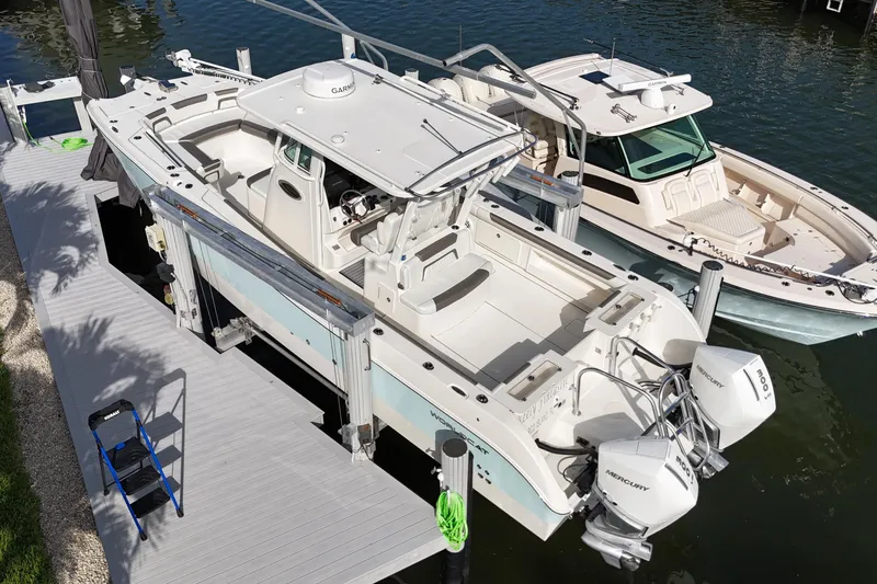 Slide: The Image of 2023 World Cat 325 CC boat docked with twin Mercury engines, aerial view. - 41