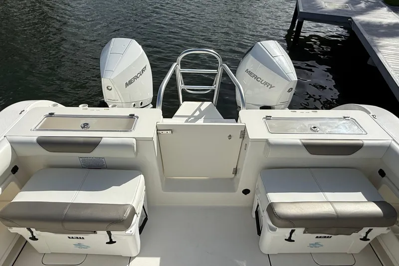 Slide: The Image of 2023 World Cat 325 CC boat with twin Mercury engines at dockside. - 43