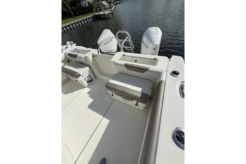 Slide: The Image of 2023 World Cat 325 CC boat deck with seating and dual Mercury engines. - 45