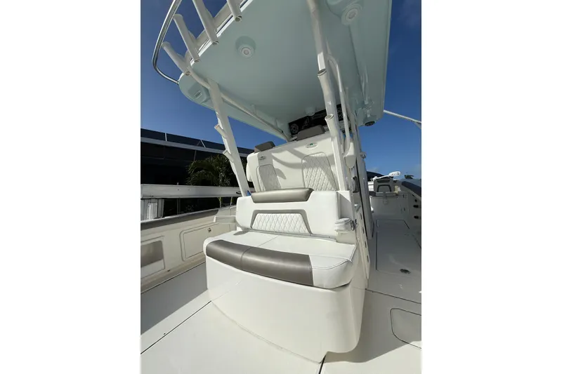 Slide: The Image of 2023 World Cat 325 CC boat interior with cushioned seating and overhead canopy. - 46