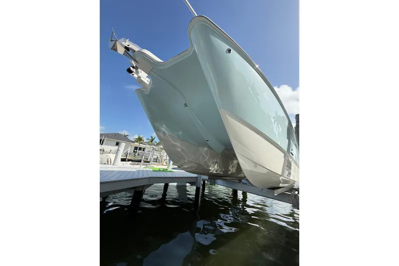 Slide: The Image of 2023 World Cat 325 CC boat docked, showcasing sleek design and modern features. - 5