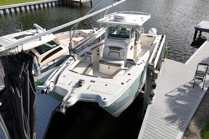 Slide: The Image of 2023 World Cat 325 CC boat docked at marina, aerial view. - 7