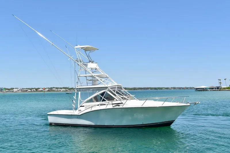 The Image of 2006 Carolina Classic 32 boat on clear blue water under a sunny sky. - 0