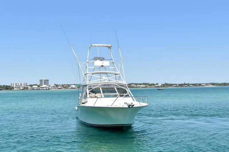 Slide: The Image of 2006 Carolina Classic 32 boat on clear blue water with coastal skyline. - 3